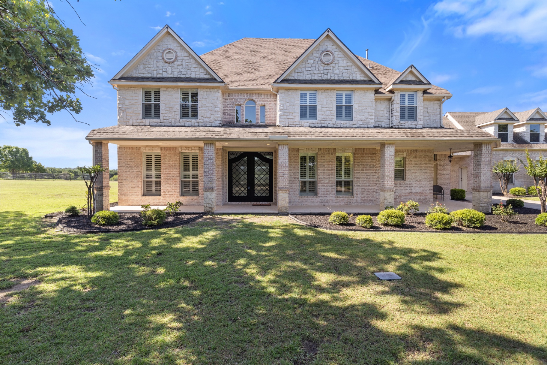 Front exterior with covered porch and dual gables