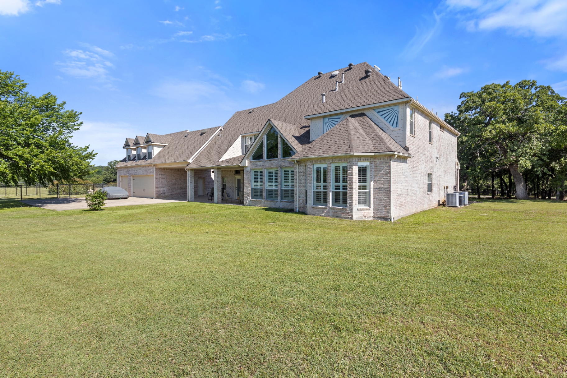 Rear elevation framed by oaks
