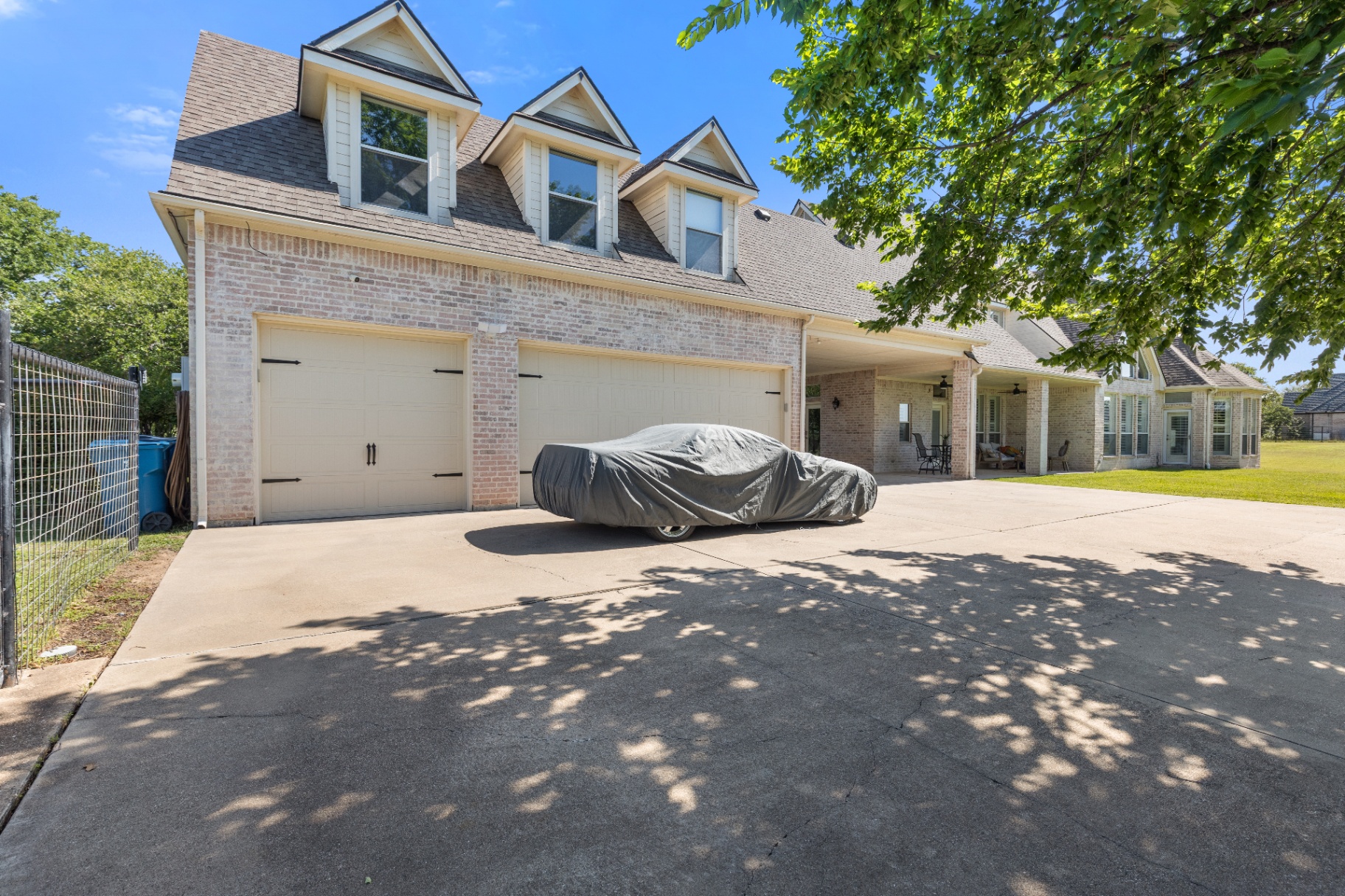 Three-car garage with covered drive