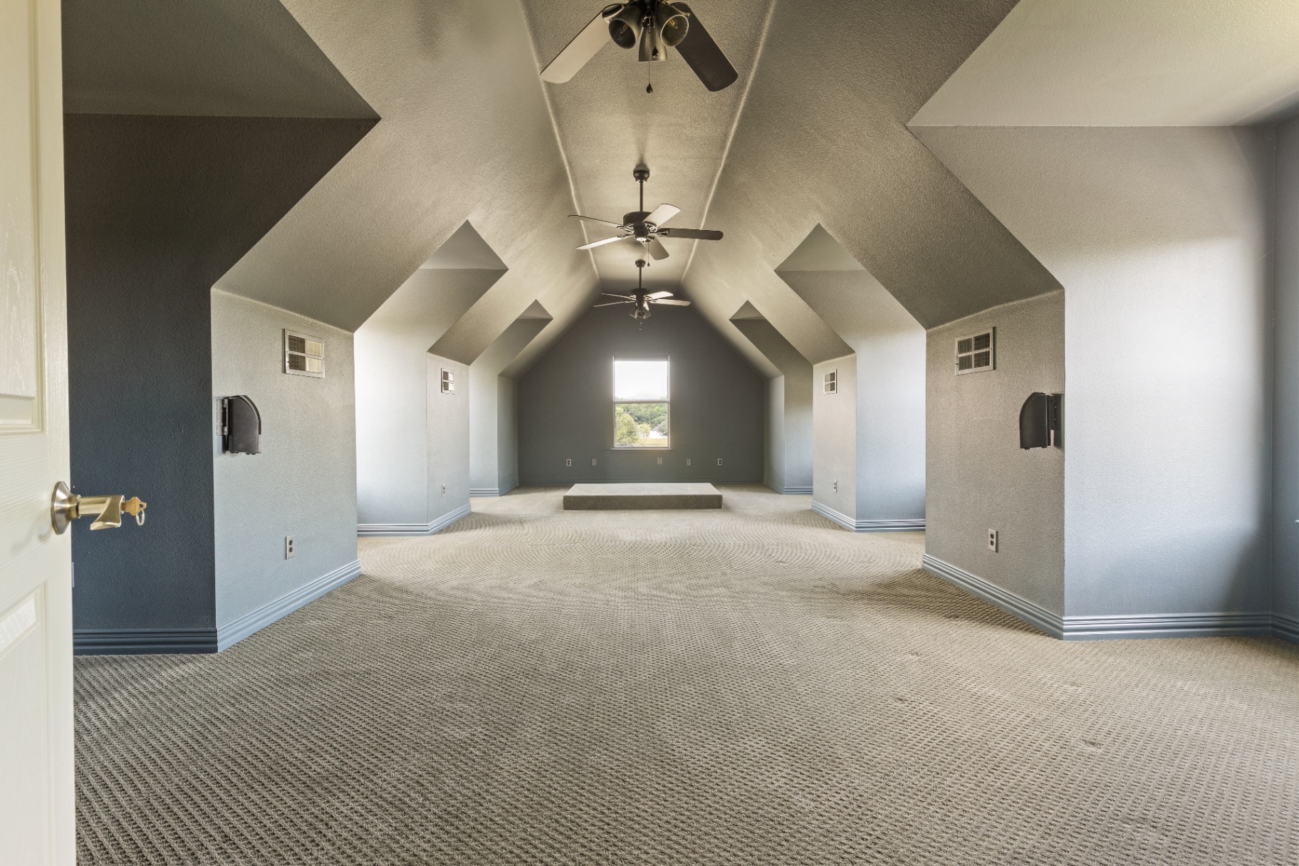 Expansive vaulted bonus room with dormers