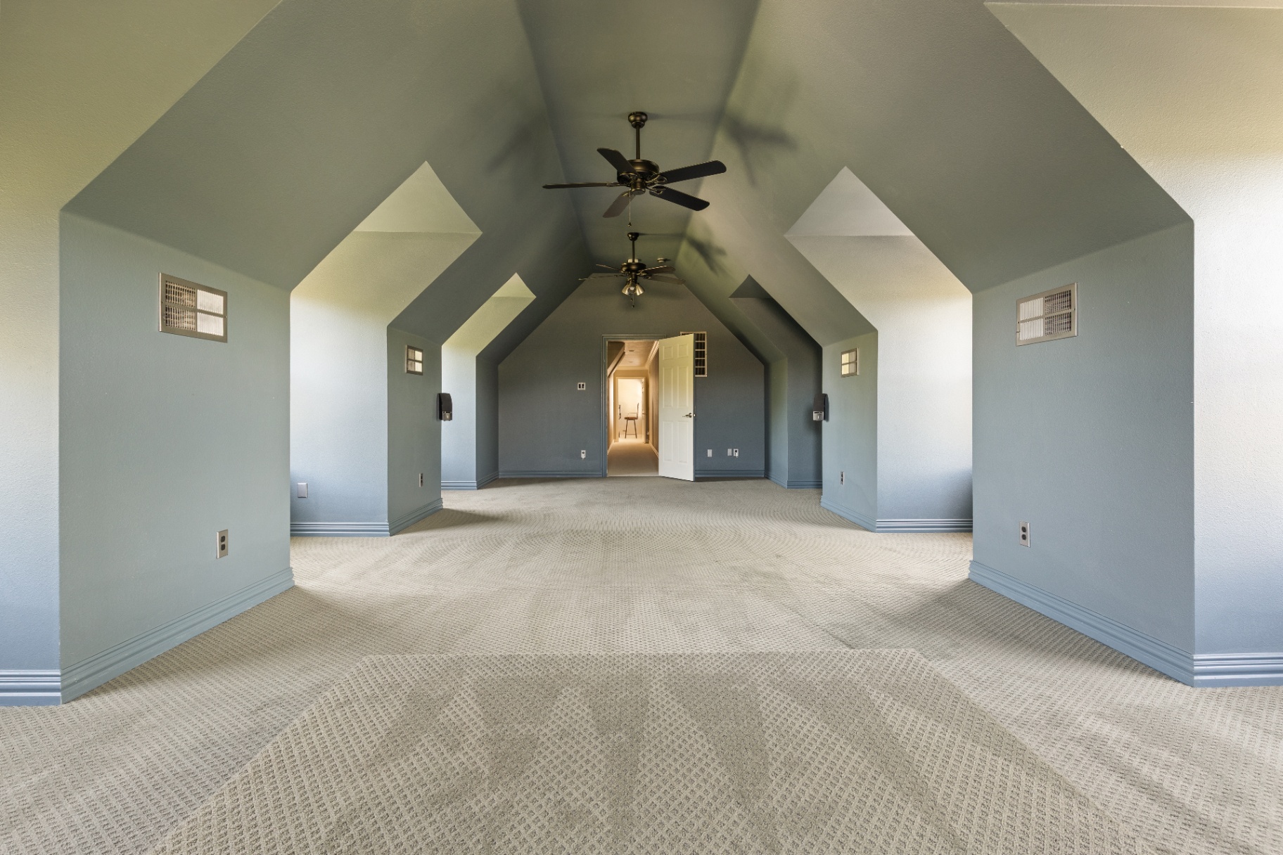 Upstairs vaulted bonus room with dual fans